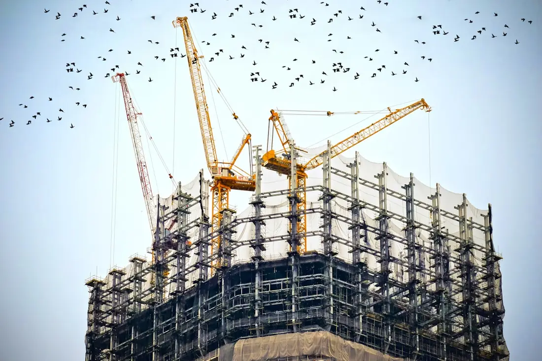 Tower cranes over a contracting construction site