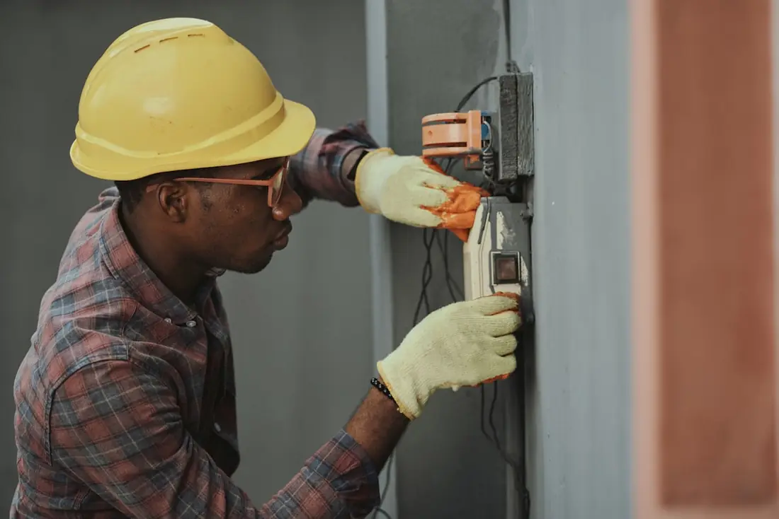 Technician carrying out electrical maintenance works